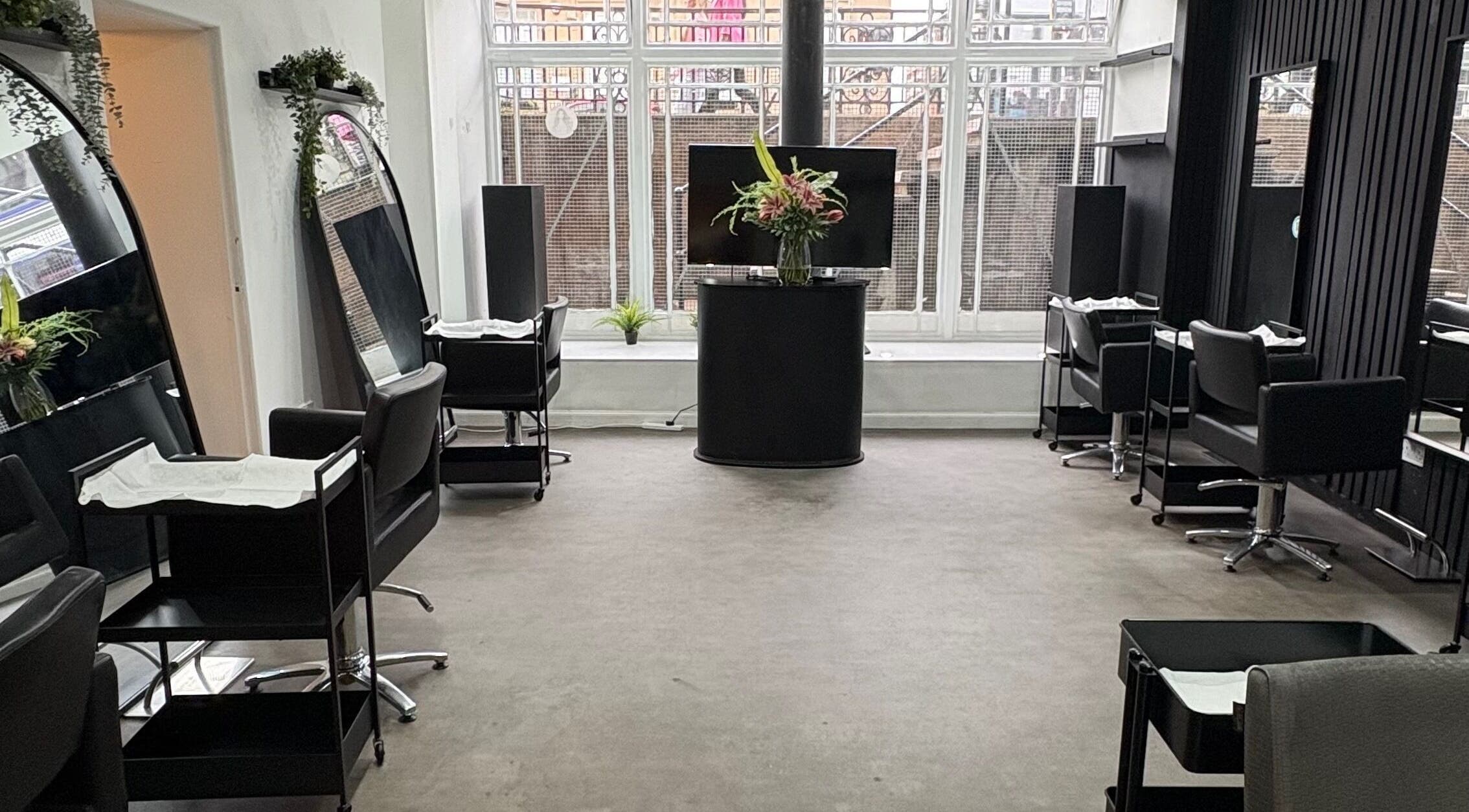 Elegant interior of The Collective Hair Co in Glasgow, Scotland, GB with modern styling stations and mirrors.