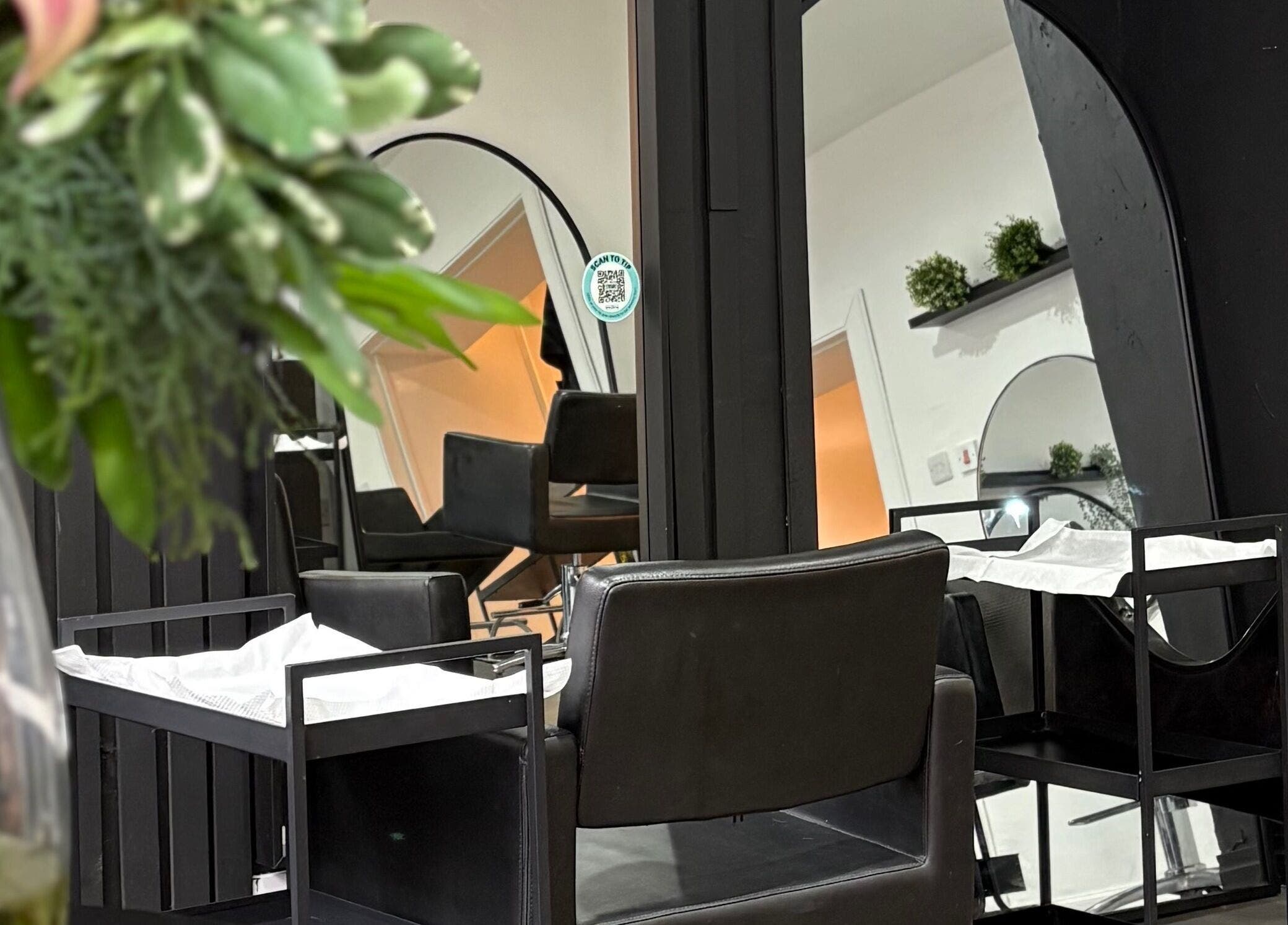 Stylish salon chair and mirror setup at The Collective Hair Co, Glasgow, Scotland, GB.