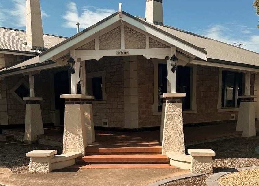 Inviting stone entrance of Ink Obsession Tattoo & Piercing in Nuriootpa, South Australia, AU under a clear blue sky.
