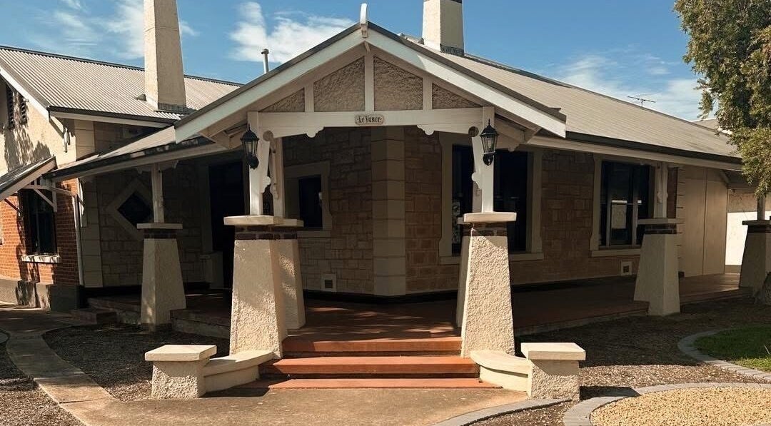 Inviting stone entrance of Ink Obsession Tattoo & Piercing in Nuriootpa, South Australia, AU under a clear blue sky.