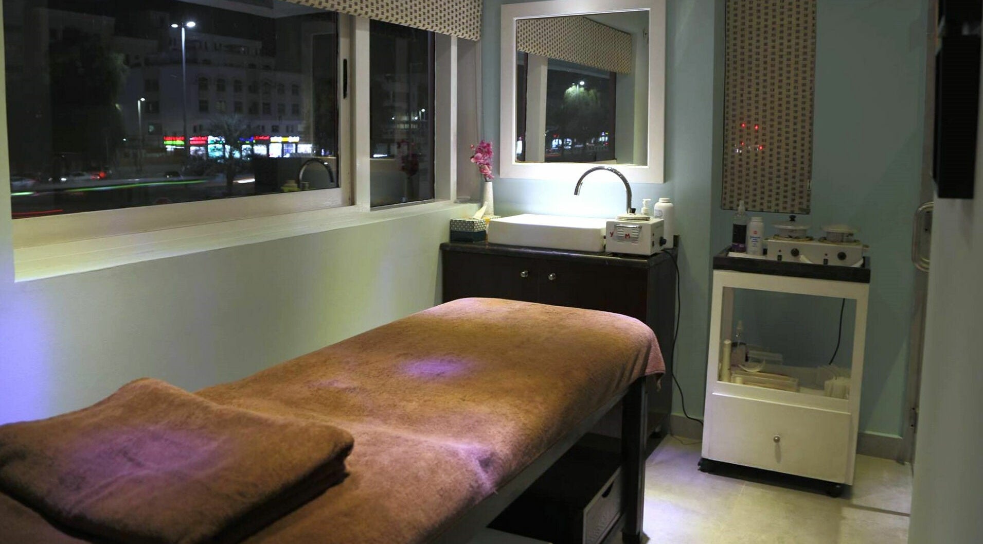 Cozy treatment room at Serene Beauty & Spa in Abu Dhabi with a massage table and tranquil lighting.