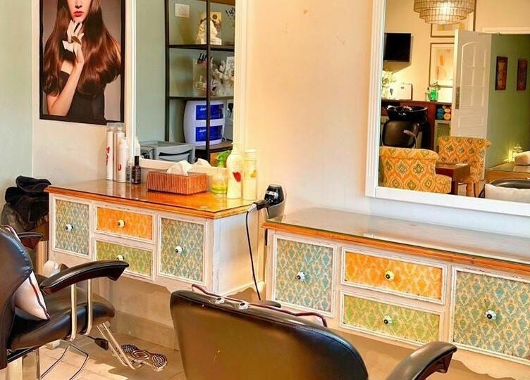 Chic styling area at Serene Beauty & Spa in Abu Dhabi, Abu Dhabi, AE features modern salon chairs and mirrors.