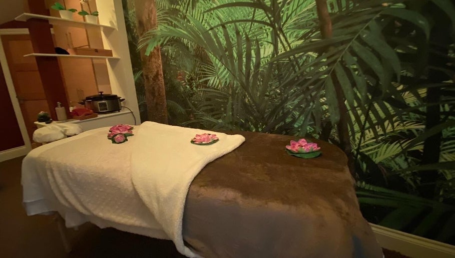 Cozy massage room at Body & Soul Luxury Treatments, Exmouth, England, GB, featuring calming green decor.