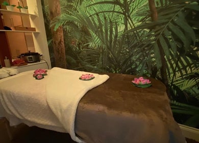 Cozy massage room at Body & Soul Luxury Treatments, Exmouth, England, GB, featuring calming green decor.