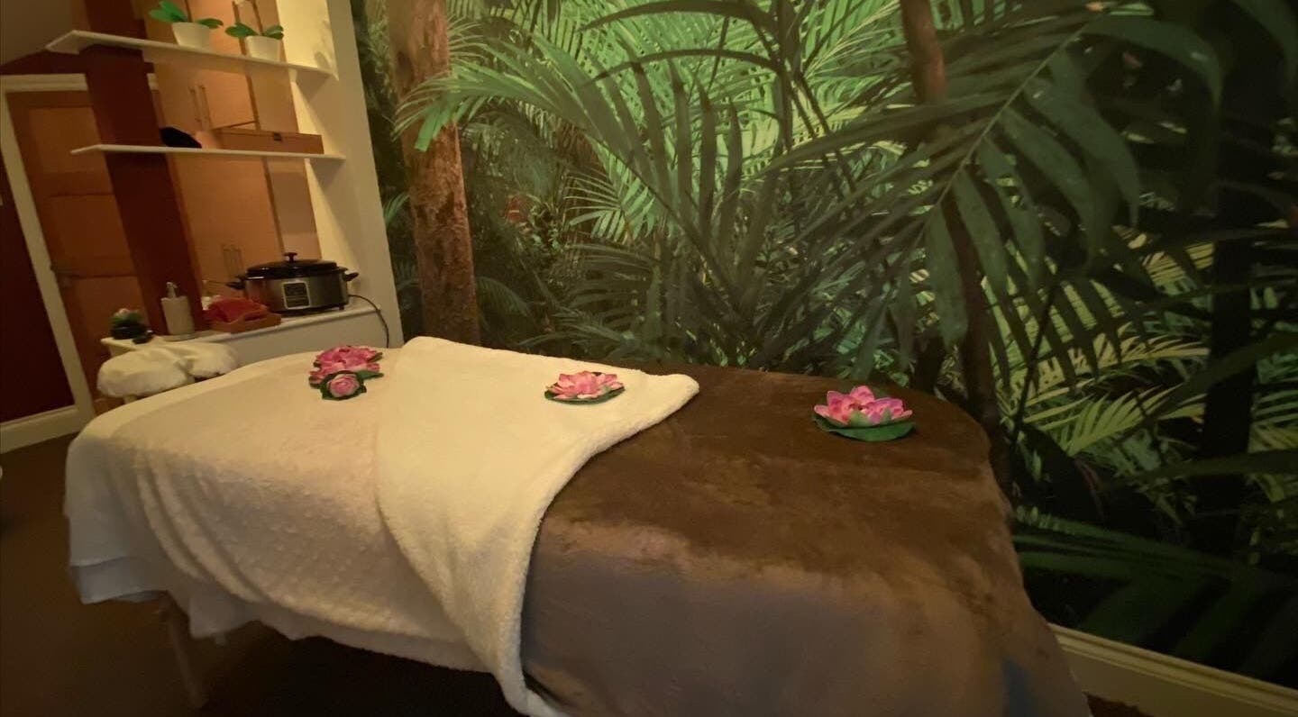 Cozy massage room at Body & Soul Luxury Treatments, Exmouth, England, GB, featuring calming green decor.