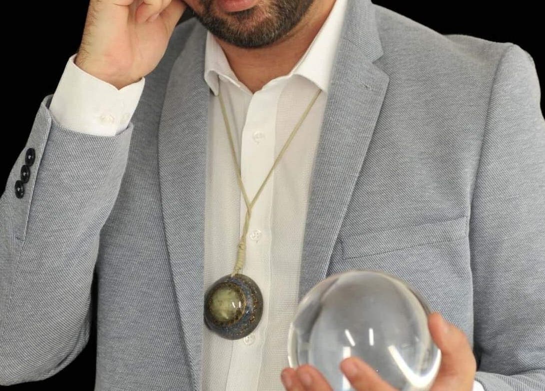 Calvin Price Psychic Medium in Llanelli, Wales, GB holding a crystal ball for a reading session.