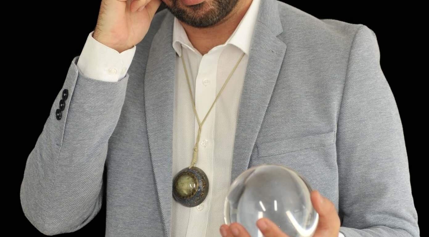 Calvin Price Psychic Medium in Llanelli, Wales, GB holding a crystal ball for a reading session.