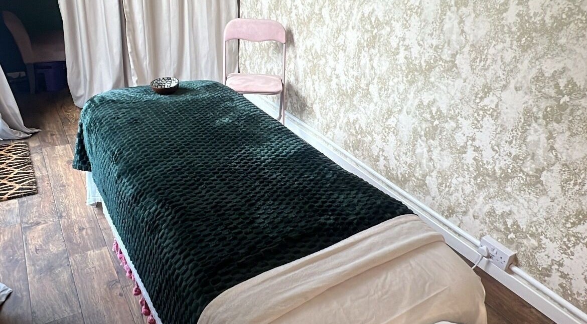 Relaxing massage table setup at Vicky Harris Beauty in Effingham, England, GB with plush linens.