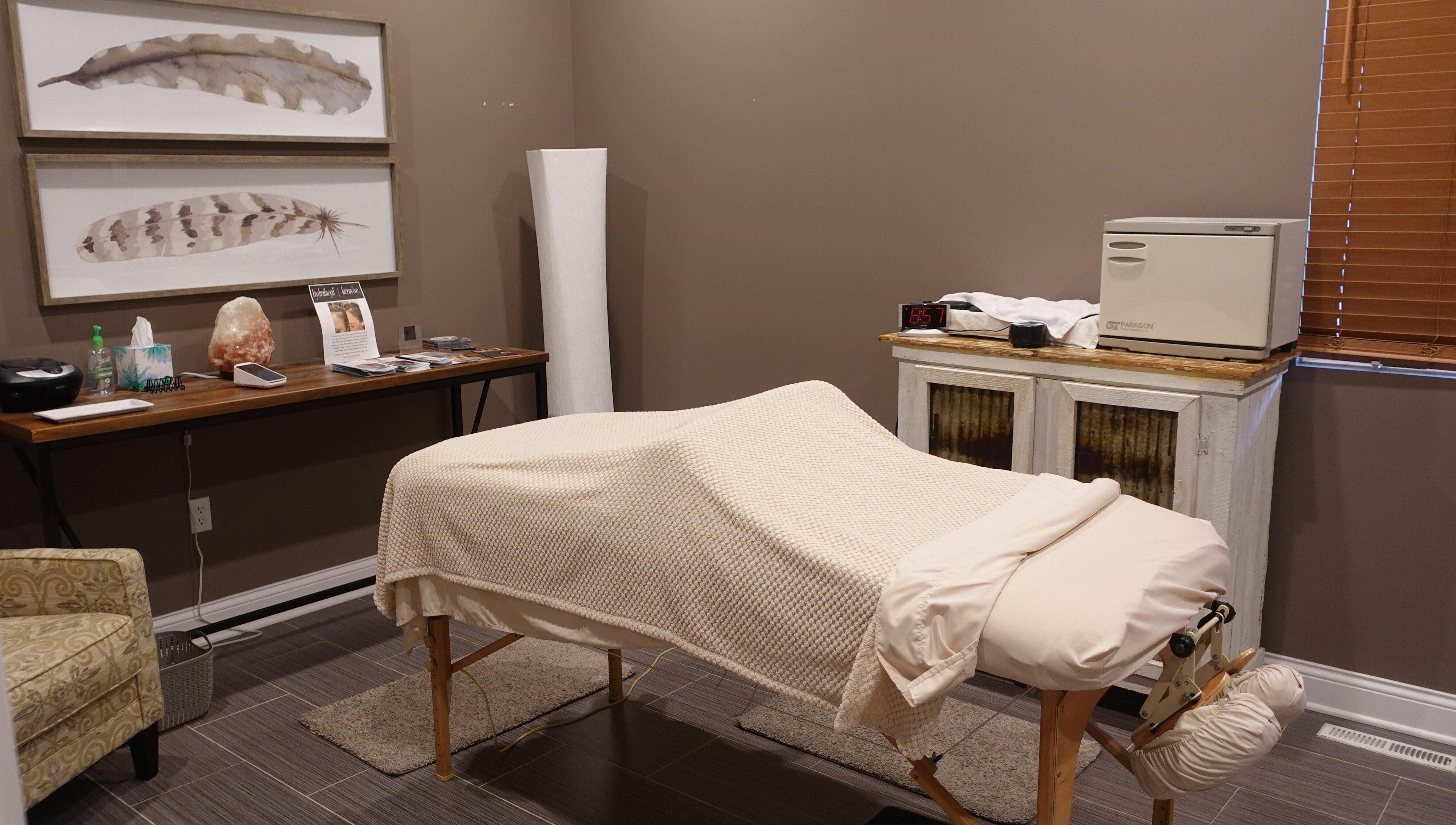 Serene spa treatment room at Geneva Salon and Spa Suites in Lake Geneva, Wisconsin, US featuring a cozy massage table.