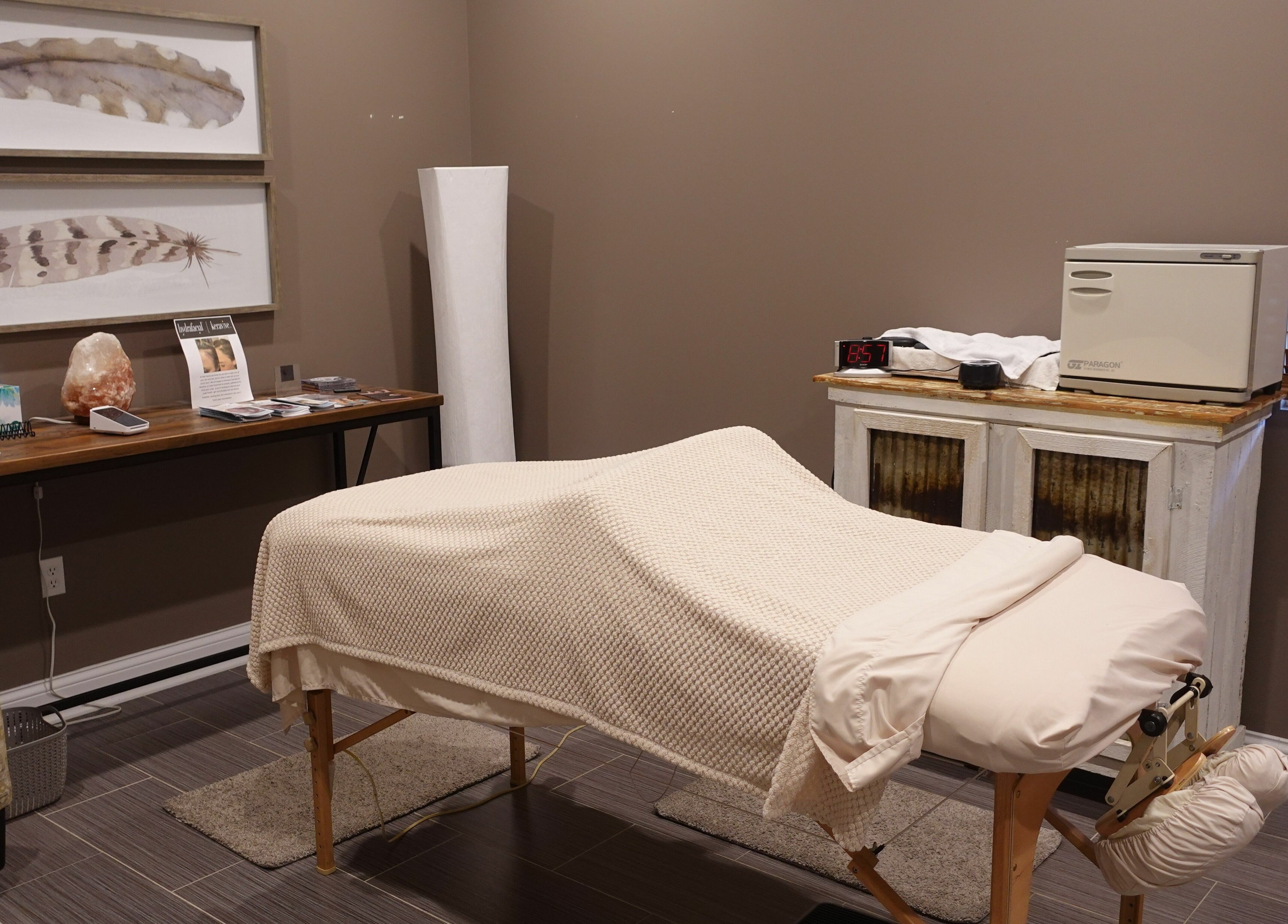 Serene spa treatment room at Geneva Salon and Spa Suites in Lake Geneva, Wisconsin, US featuring a cozy massage table.
