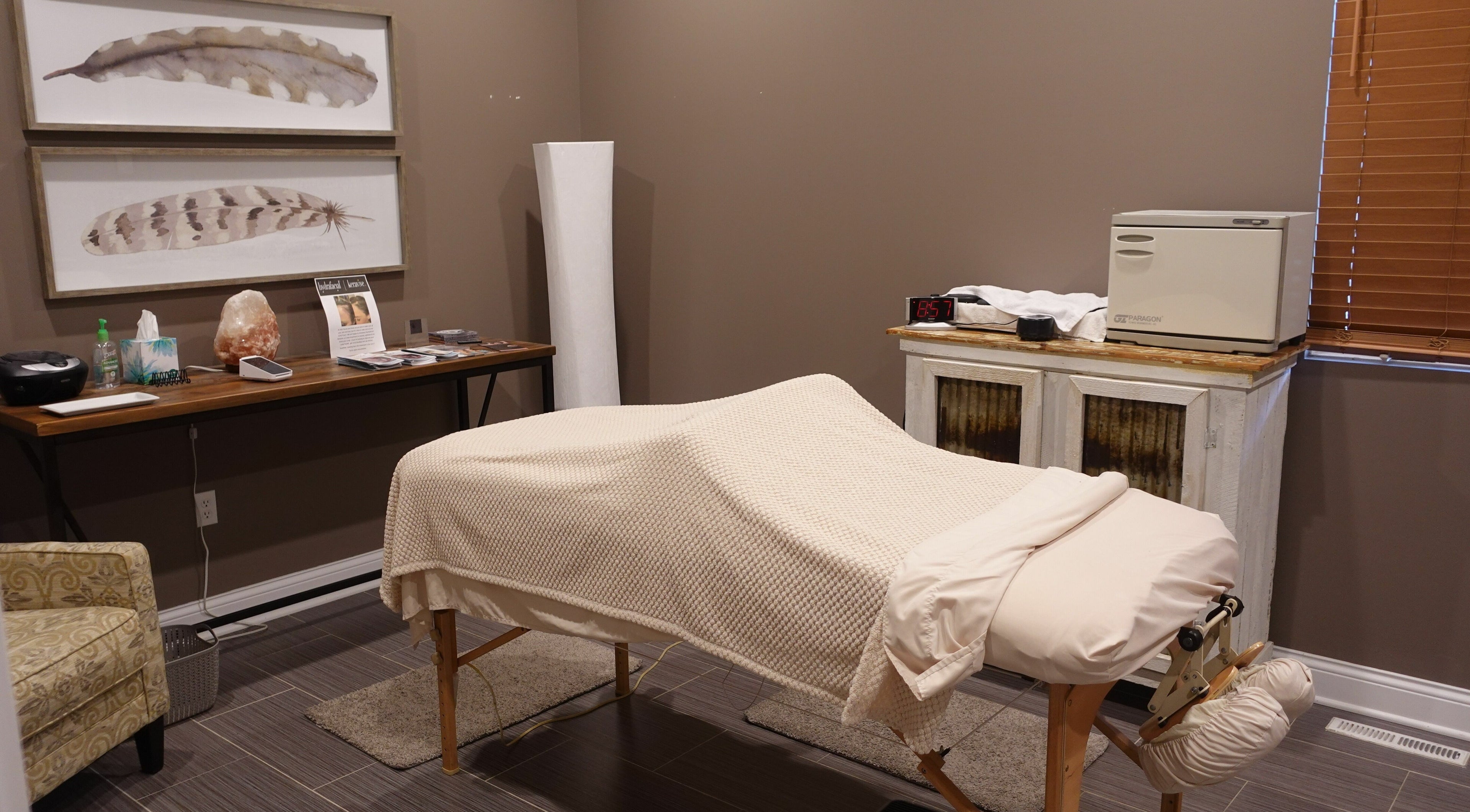 Serene spa treatment room at Geneva Salon and Spa Suites in Lake Geneva, Wisconsin, US featuring a cozy massage table.