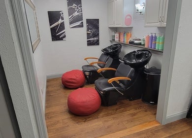 Elegant hair washing station at Bella Lina Salon in Warwick, Rhode Island, US, featuring modern chairs and decor.