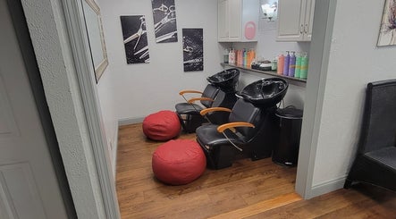 Elegant hair washing station at Bella Lina Salon in Warwick, Rhode Island, US, featuring modern chairs and decor.