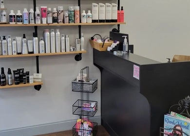 Product shelves at Bella Lina Salon in Warwick, Rhode Island, US, showcasing premium beauty products.