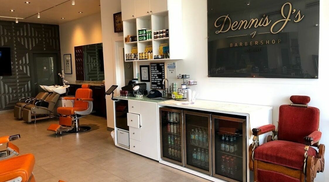 Modern interior of Dennis J's Barbershop in Fort Lauderdale, Florida, US showcasing seating and refreshments.