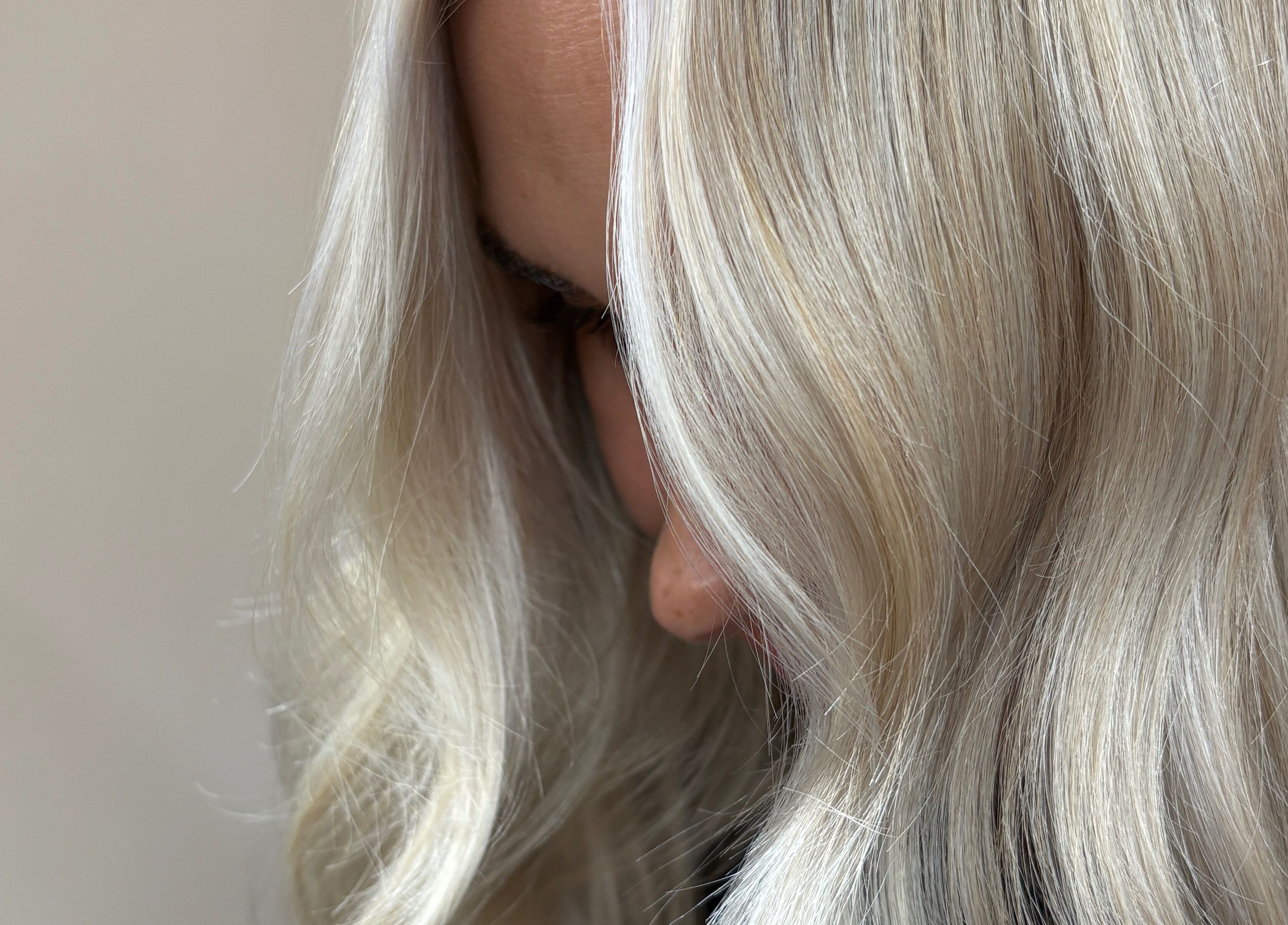 Close-up of sleek blonde hair styled at THE Hairdressers in Lowestoft, England, GB.