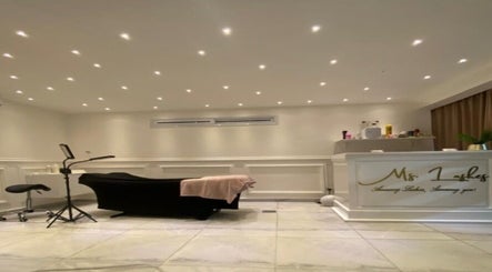 Elegant interior of Ms. Lashes - Papaya Street, Accra. Features treatment bed and lighting.