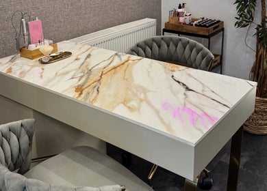 Elegant marble salon station at Edgars Hair Salon, West Bromwich, England, GB, with plush seats and decor.