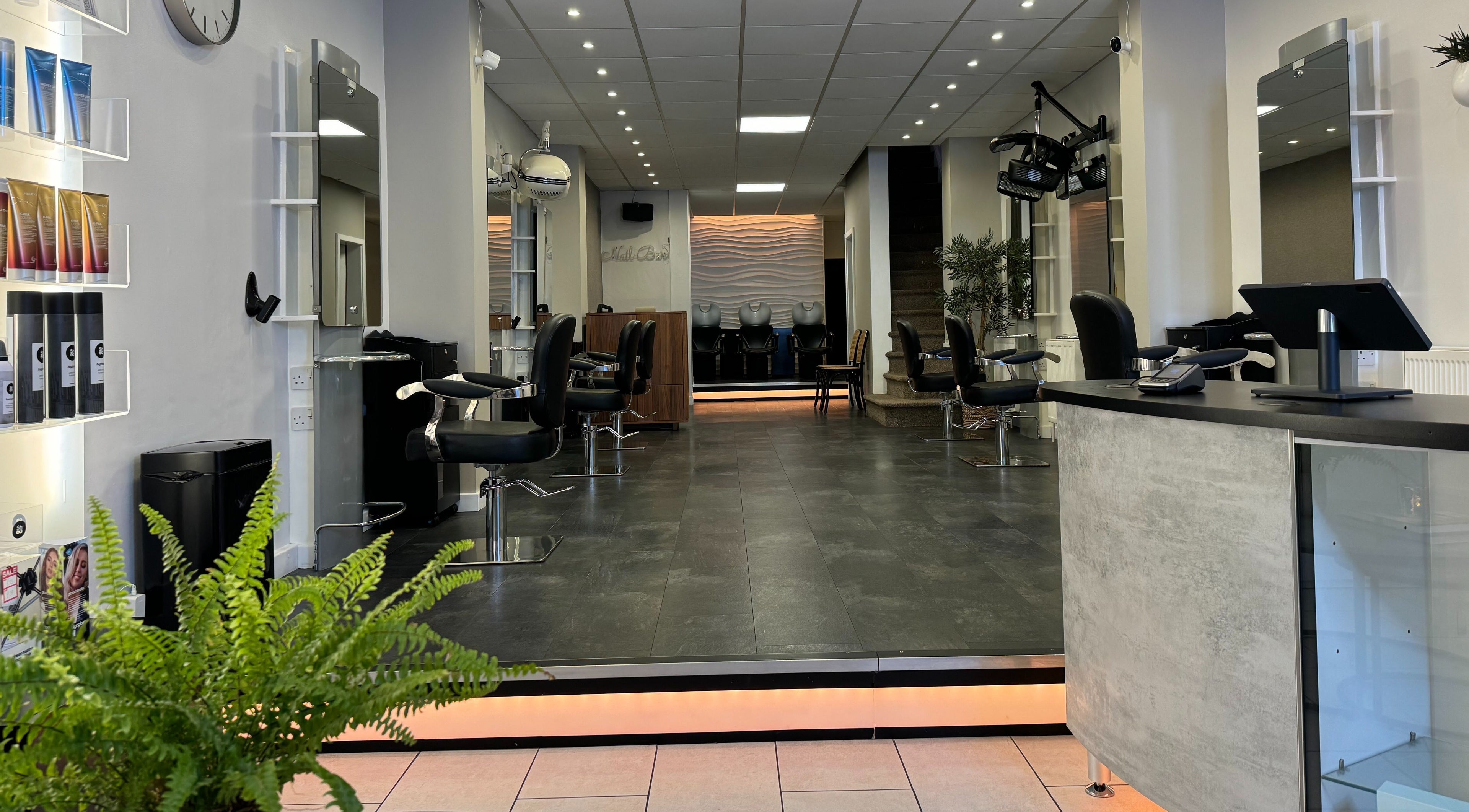 Modern interior of Edgars Hair Salon in West Bromwich, England, GB, featuring sleek styling chairs and bright decor.