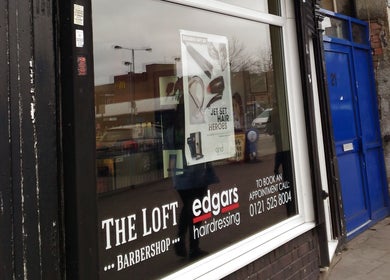 Front window of Edgars Hair Salon in West Bromwich, England, GB showing stylish salon branding.
