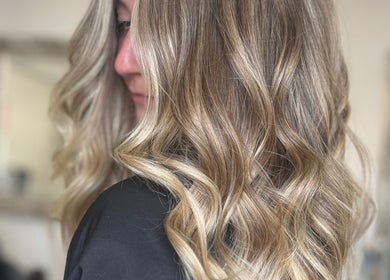 Blonde hair styled in loose curls at Aurora House of Beauty, Eccles, England, GB.