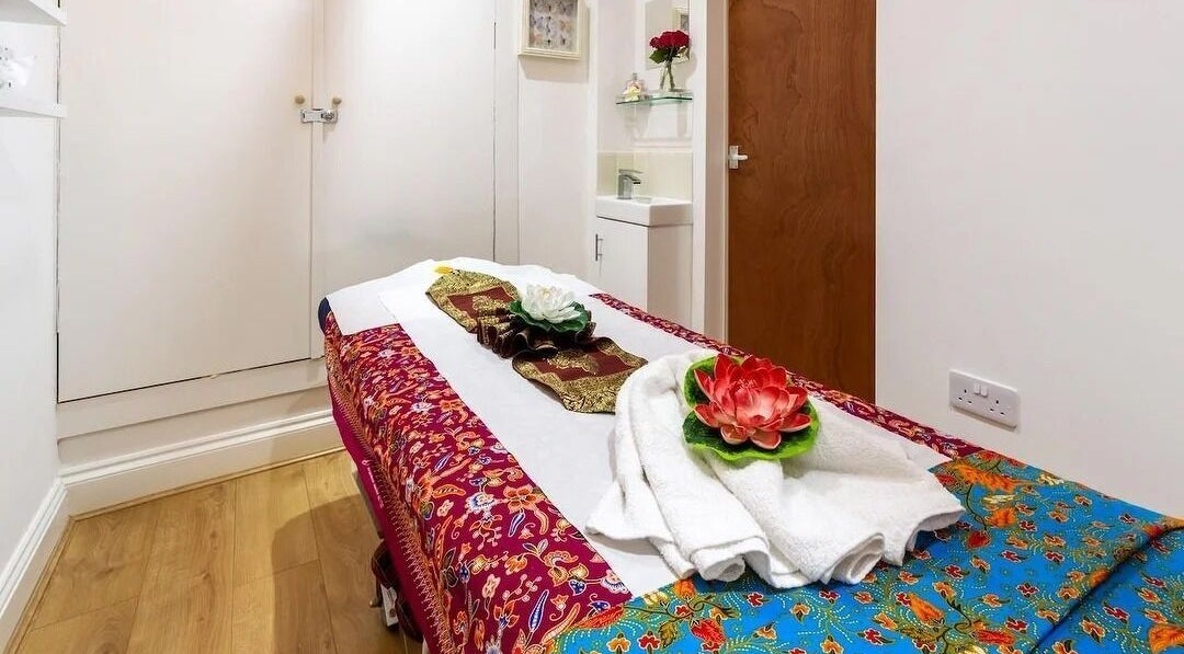 Tranquil massage room at 1689 Thai Massage Therapy in London, England, GB beautifully arranged with floral decor.