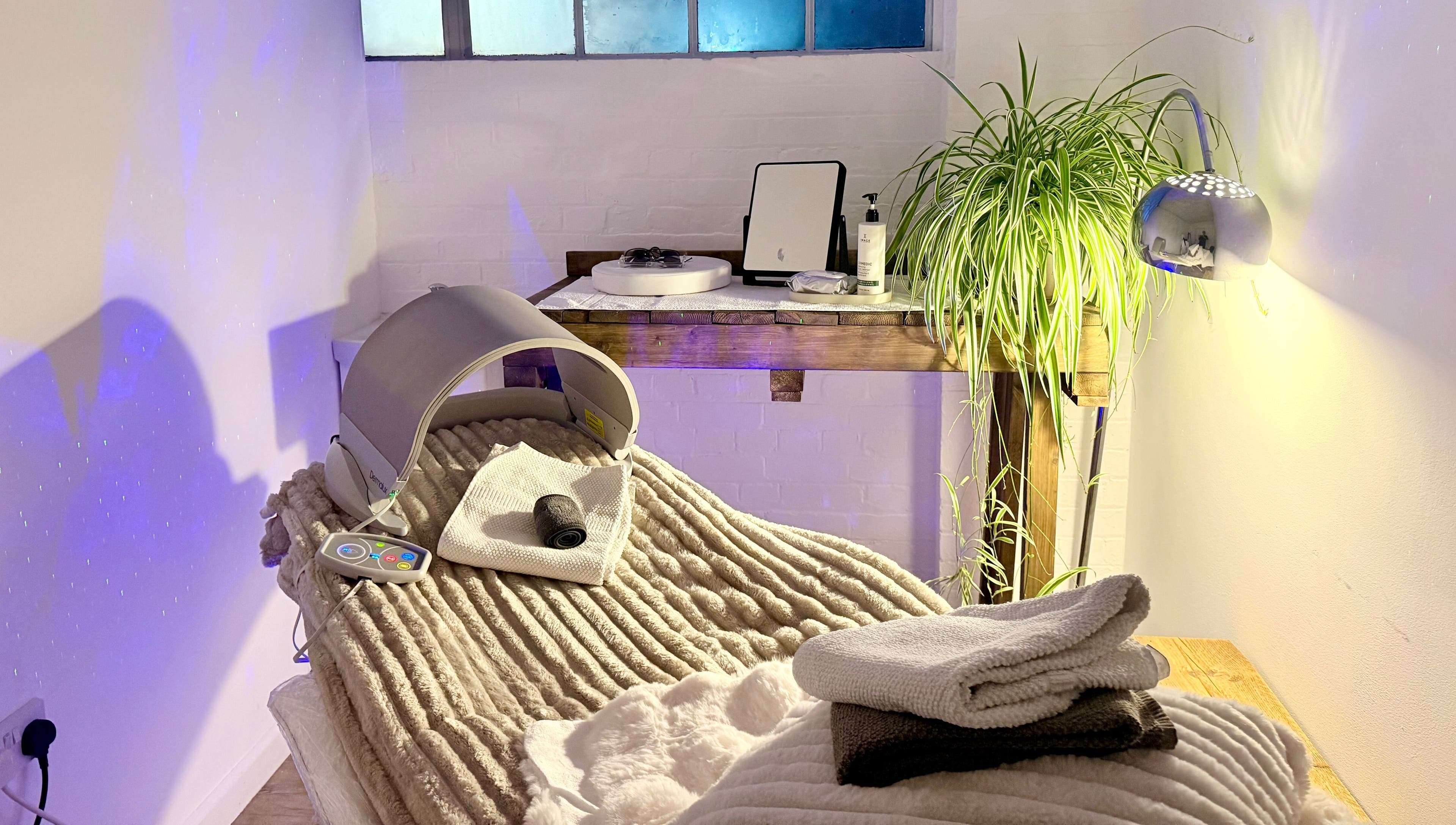 Relaxing spa setup at at1.AESTHETICS in Nottingham, England, GB with plush blanket and soothing light.