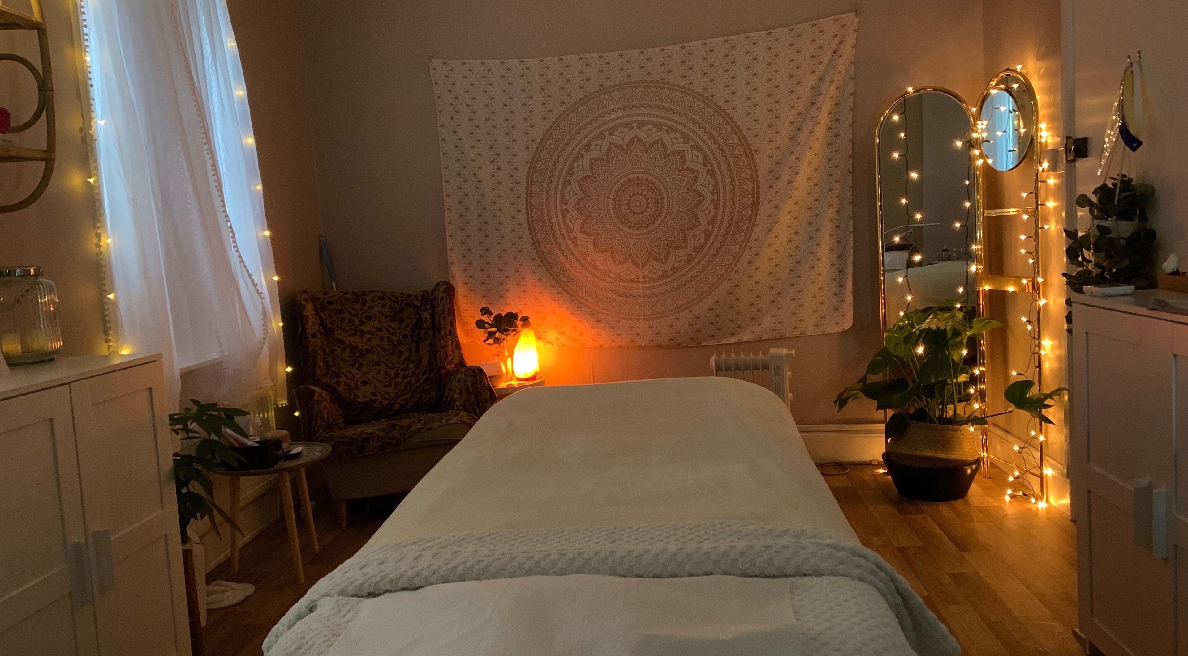 Cozy treatment room at E.R Holistic Beauty in Southwell, England, GB, warmly lit with fairy lights.