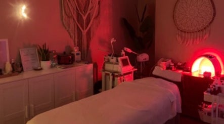 Cozy treatment room at E.R Holistic Beauty, Southwell, England, GB, with calming light and modern equipment.