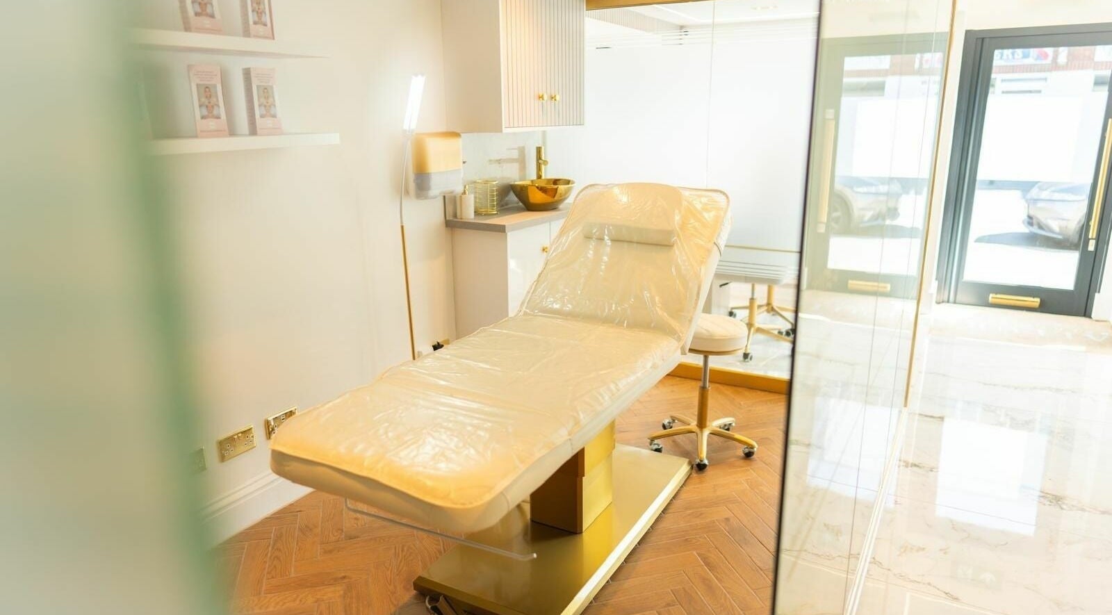 Relaxing treatment room at Mirella Beauty Treatments, Peacehaven, England, GB with plush cream therapy bed.