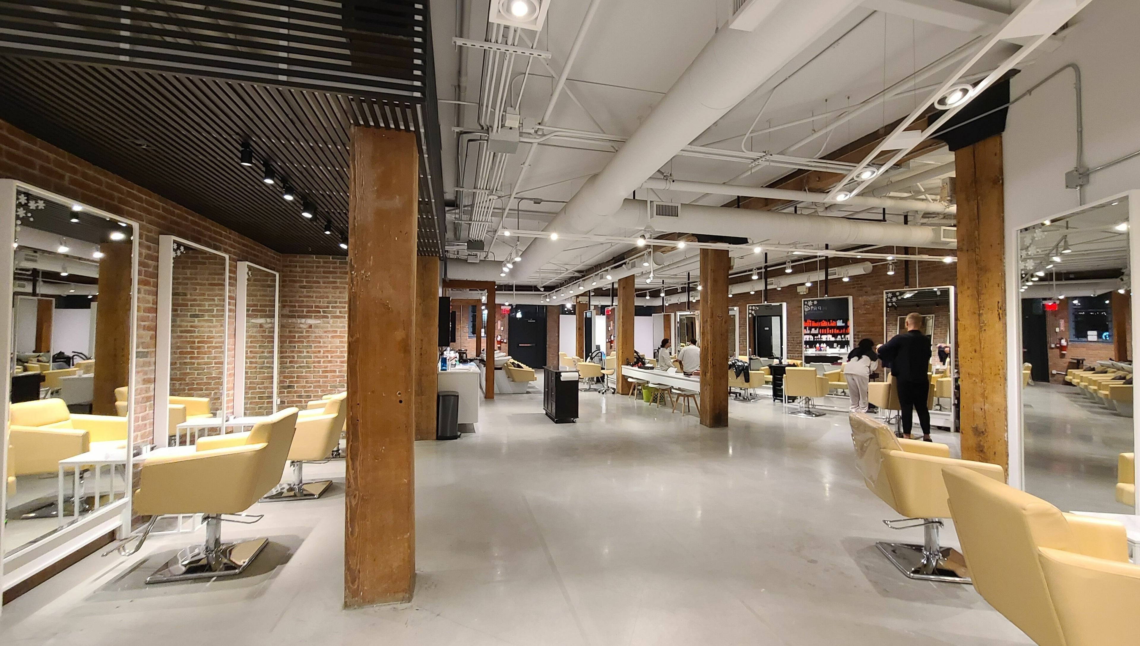 Modern interior of M Prive Salon, Vancouver, British Columbia, CA showing stylish chairs and mirrors.