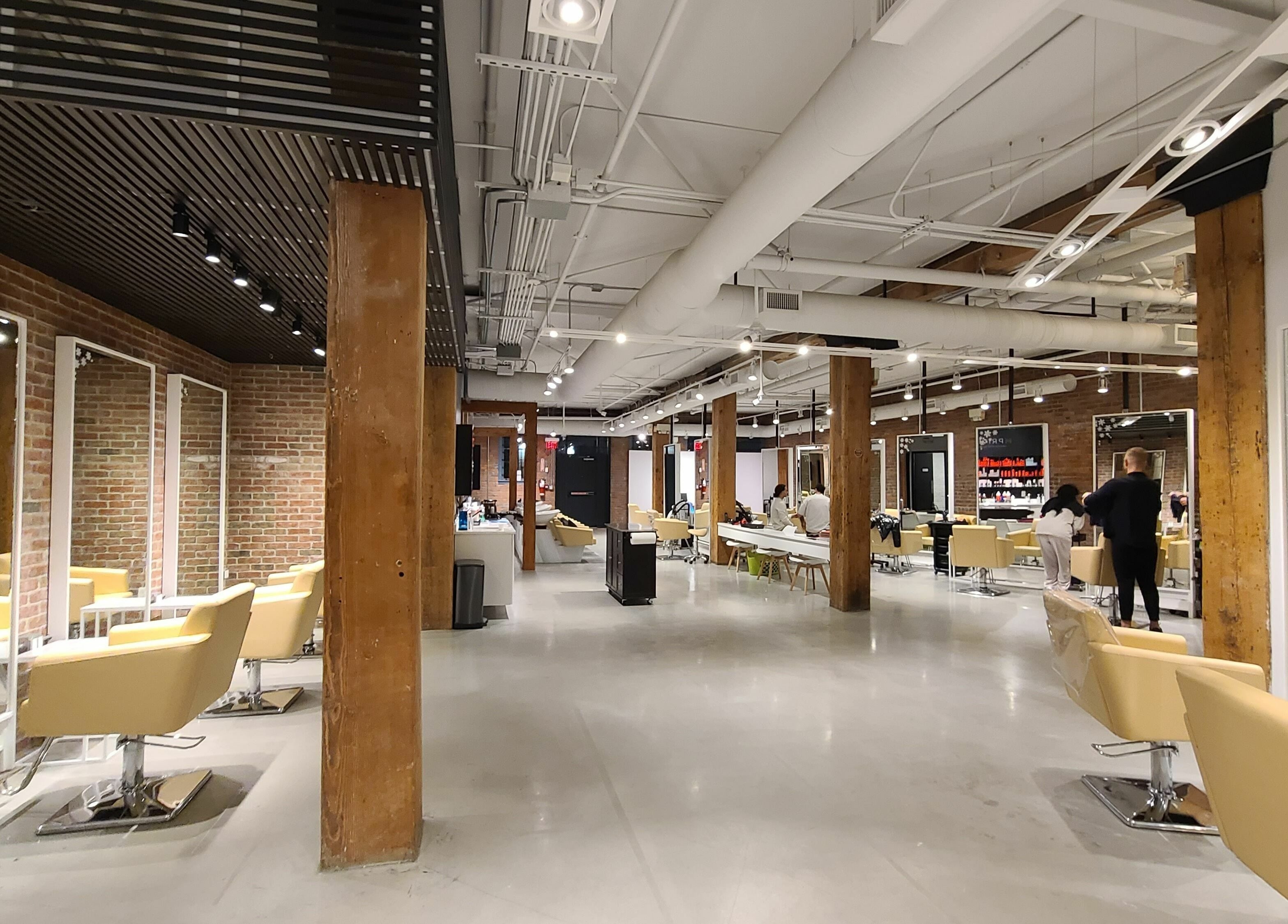 Modern interior of M Prive Salon, Vancouver, British Columbia, CA showing stylish chairs and mirrors.