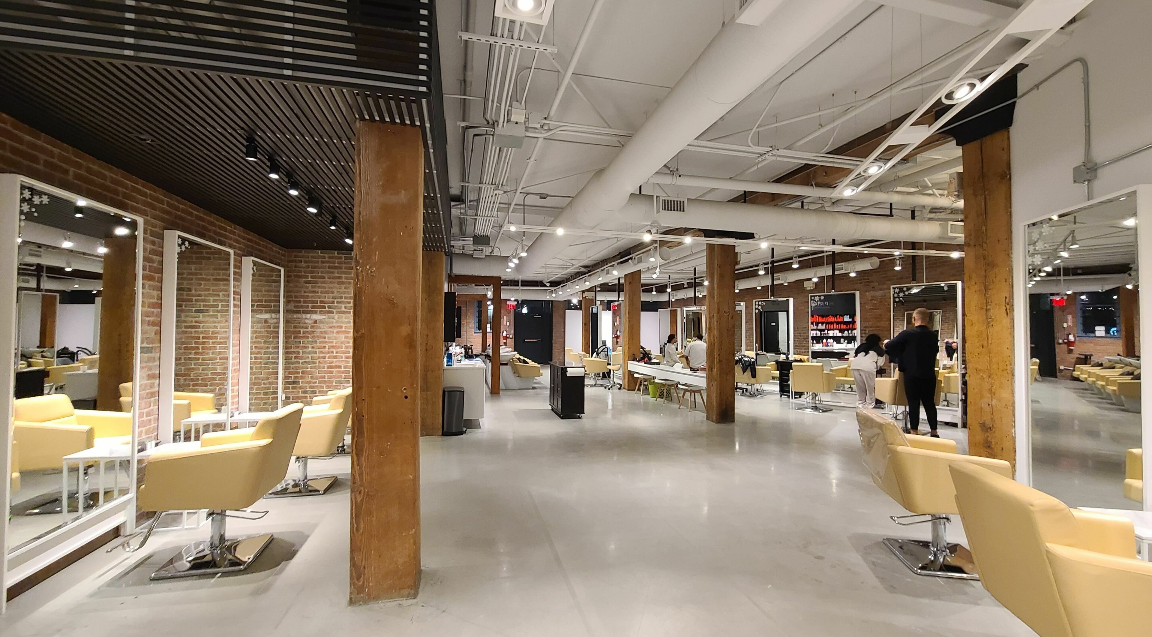 Modern interior of M Prive Salon, Vancouver, British Columbia, CA showing stylish chairs and mirrors.