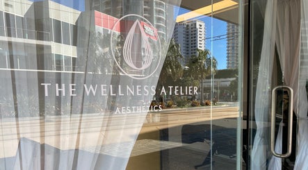 Entrance to The Wellness Atelier in Coolangatta, Queensland, AU, showcasing elegant glass facade.