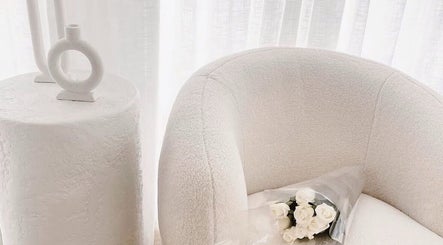 Elegant lounge area with white chair and roses at The Wellness Atelier, Coolangatta, Queensland, AU.