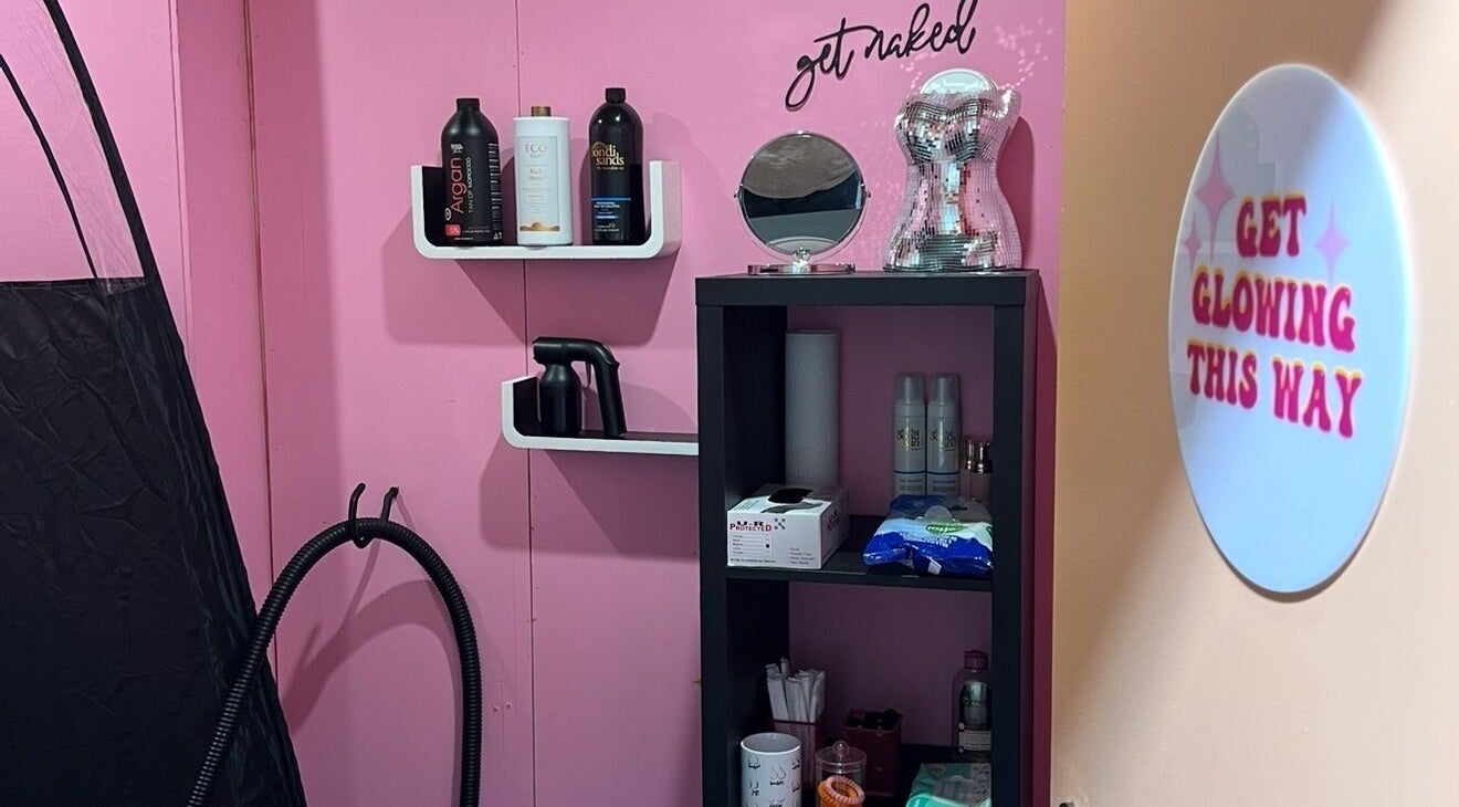 Polished By Court's pink beauty corner in Auckland, NZ, featuring tanning supplies and glow signs.