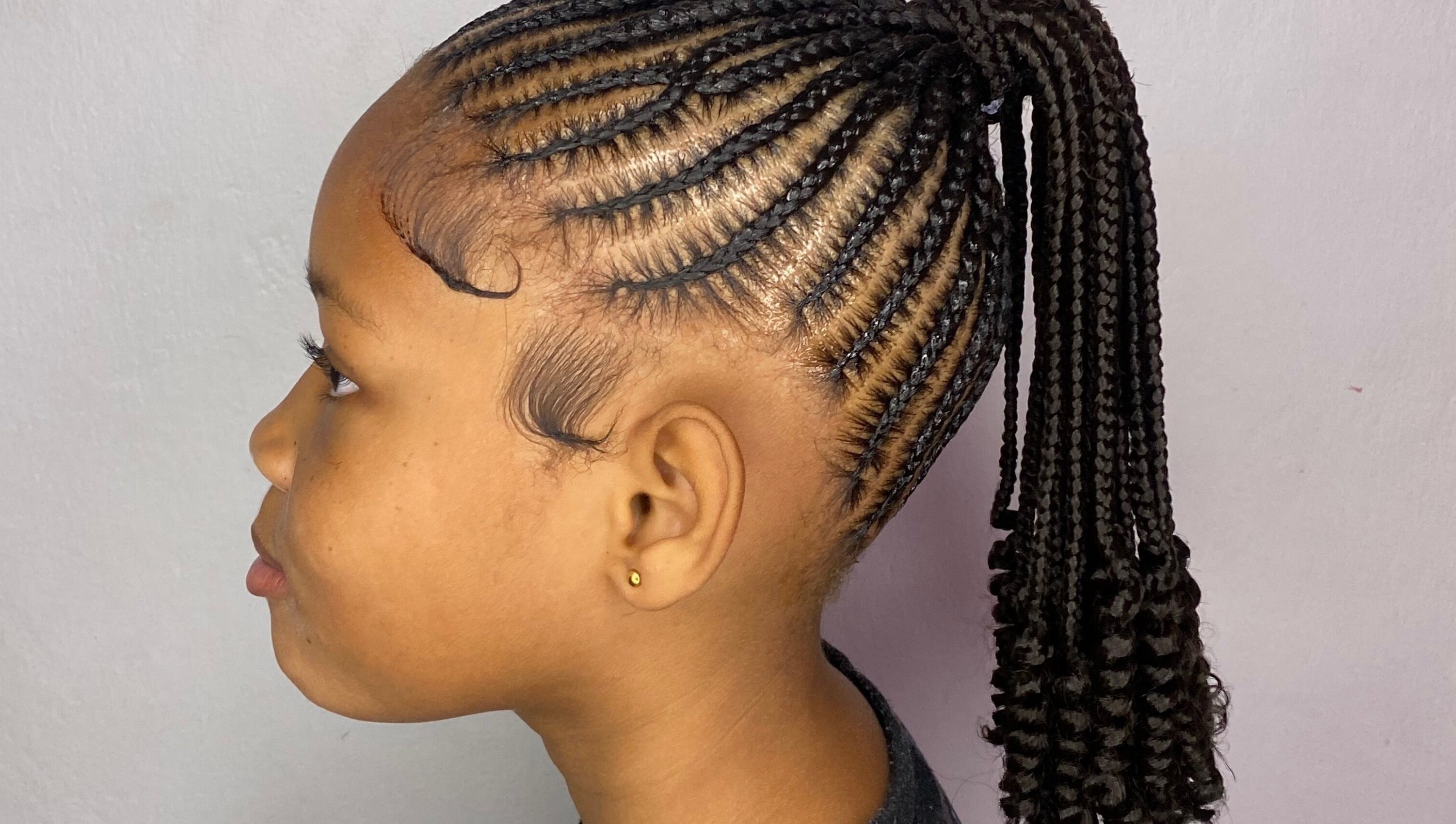 Stylish braided hairstyle at Mona's Beauty Spot, Bridgetown, Saint Philip, BB.