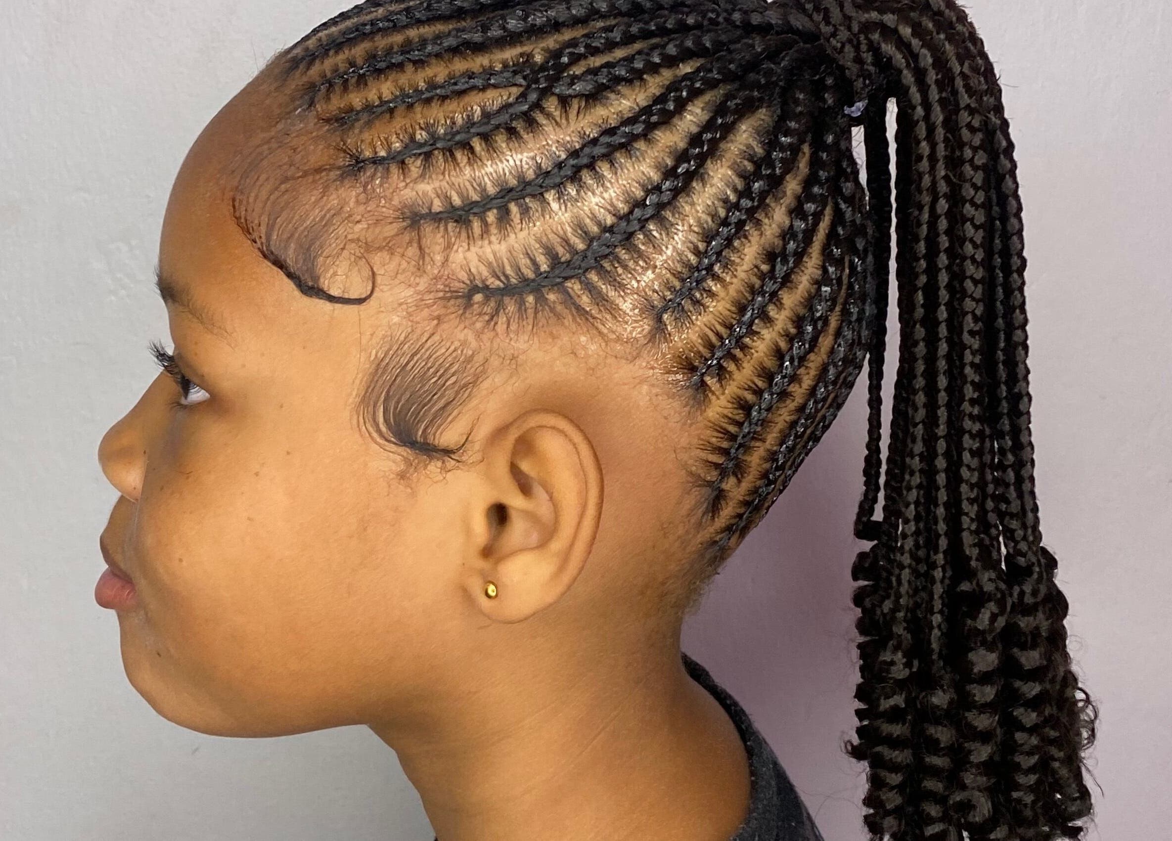 Stylish braided hairstyle at Mona's Beauty Spot, Bridgetown, Saint Philip, BB.
