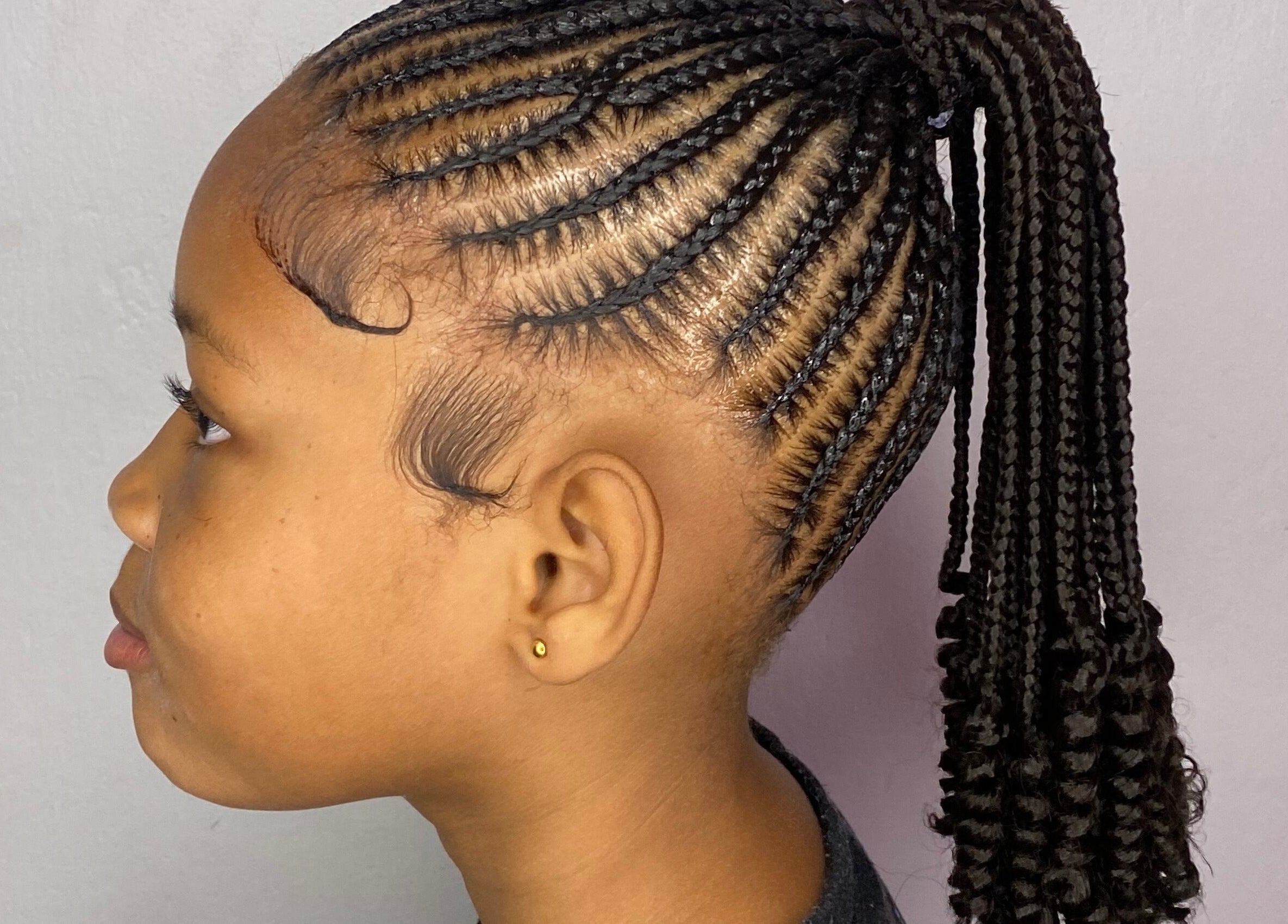 Stylish braided hairstyle at Mona's Beauty Spot, Bridgetown, Saint Philip, BB.