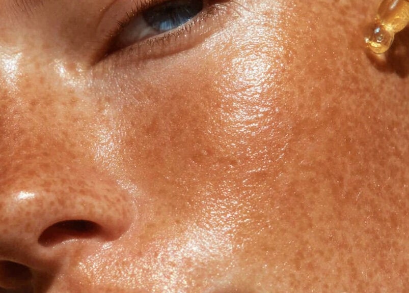 Close-up of radiant skin with serum applied at Lucia Skincare, Newbury, England, GB.