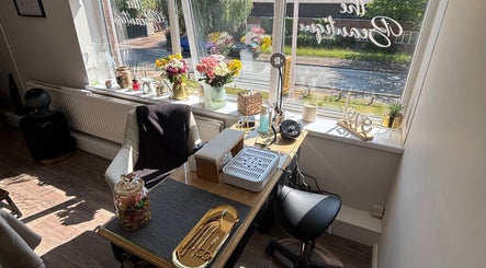 Bright and inviting beauty workspace at The Beautique, Atherstone, England, GB, featuring flowers and decor.