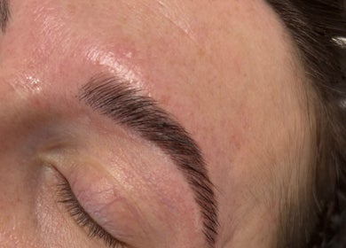 Close-up of freshly groomed eyebrow at The Beautique, Atherstone, England, GB showcasing expert beauty care.