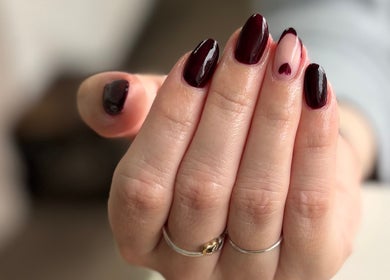 Elegant burgundy manicure at The Beautique in Atherstone, England, GB, showcasing exquisite nail art.