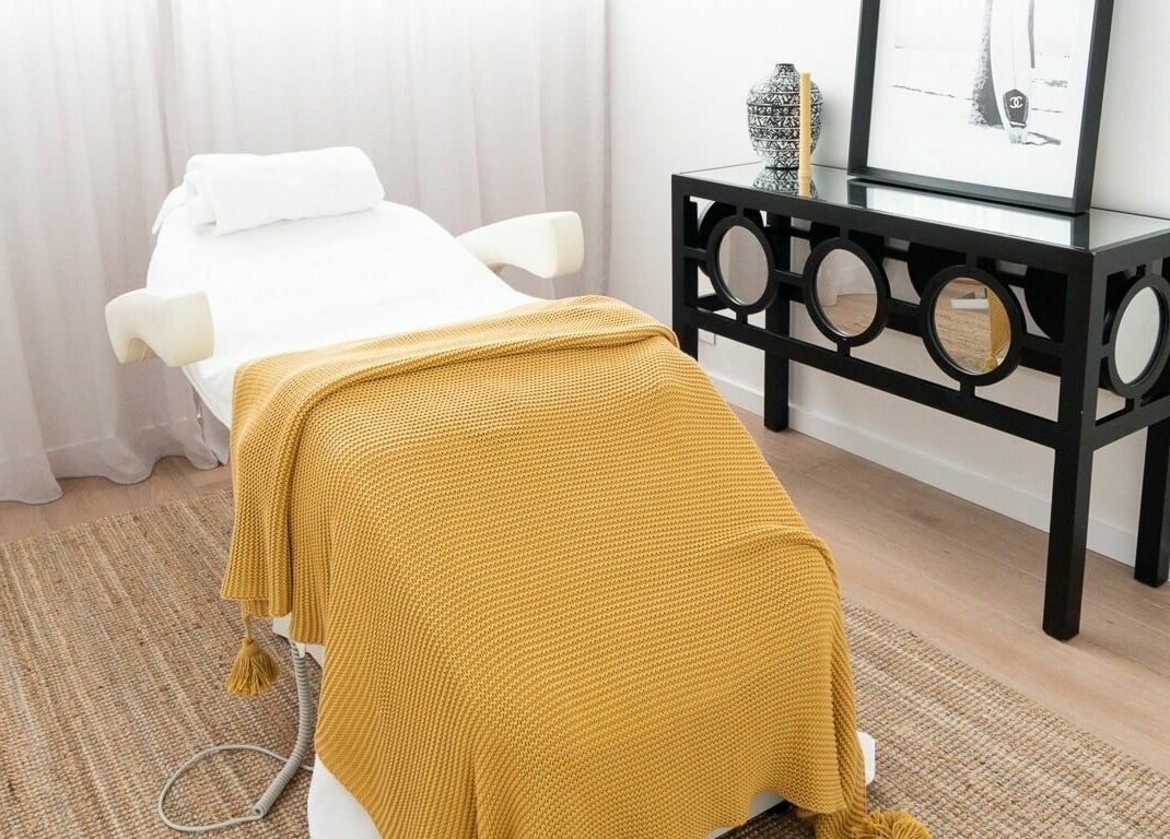 Tranquil spa treatment room at By Stella, Cronulla, New South Wales, AU with cozy blanket on massage table.
