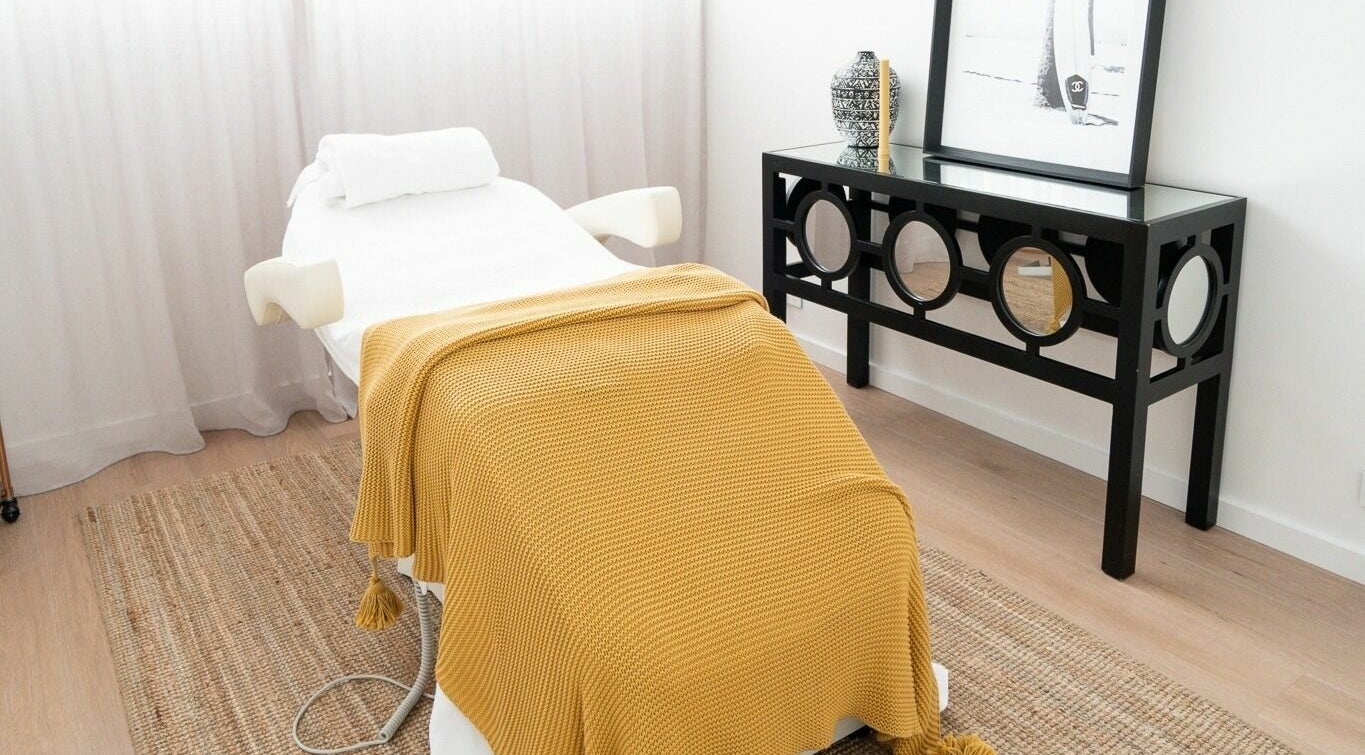 Tranquil spa treatment room at By Stella, Cronulla, New South Wales, AU with cozy blanket on massage table.