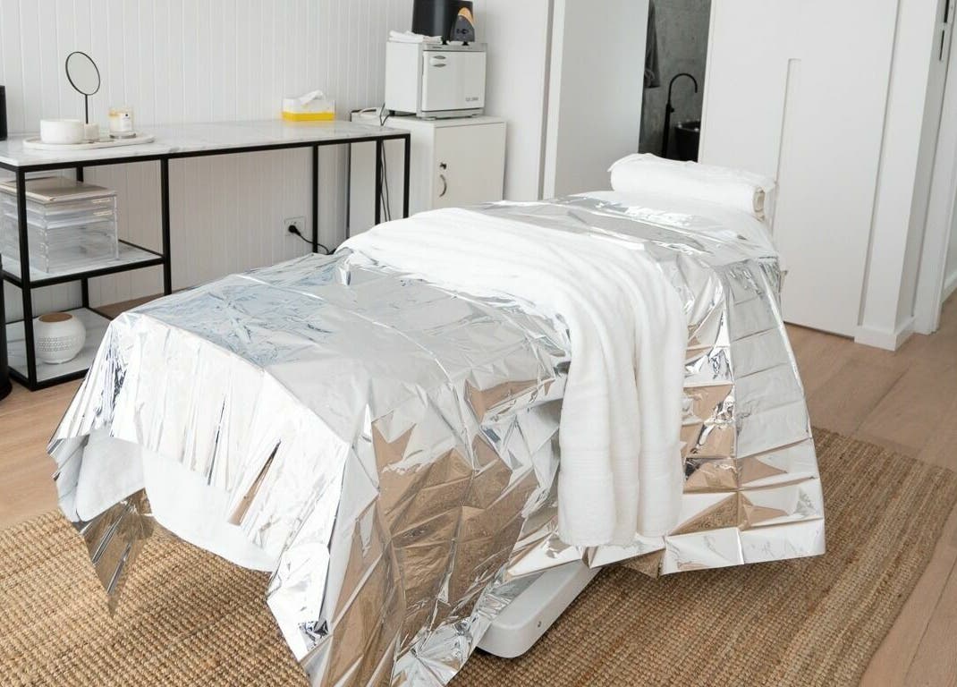 Spa treatment room at By Stella, Cronulla, New South Wales, AU with a metallic blanket on a massage table.