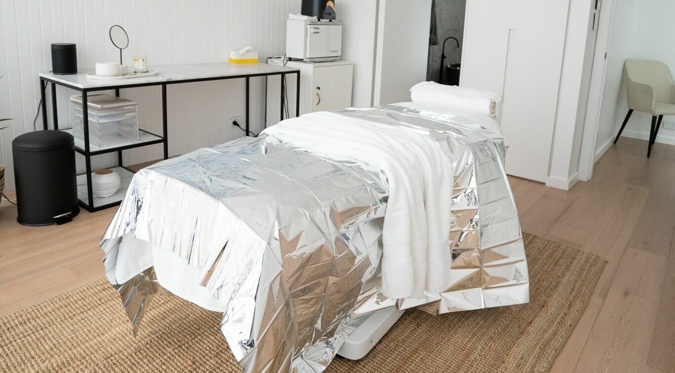 Spa treatment room at By Stella, Cronulla, New South Wales, AU with a metallic blanket on a massage table.