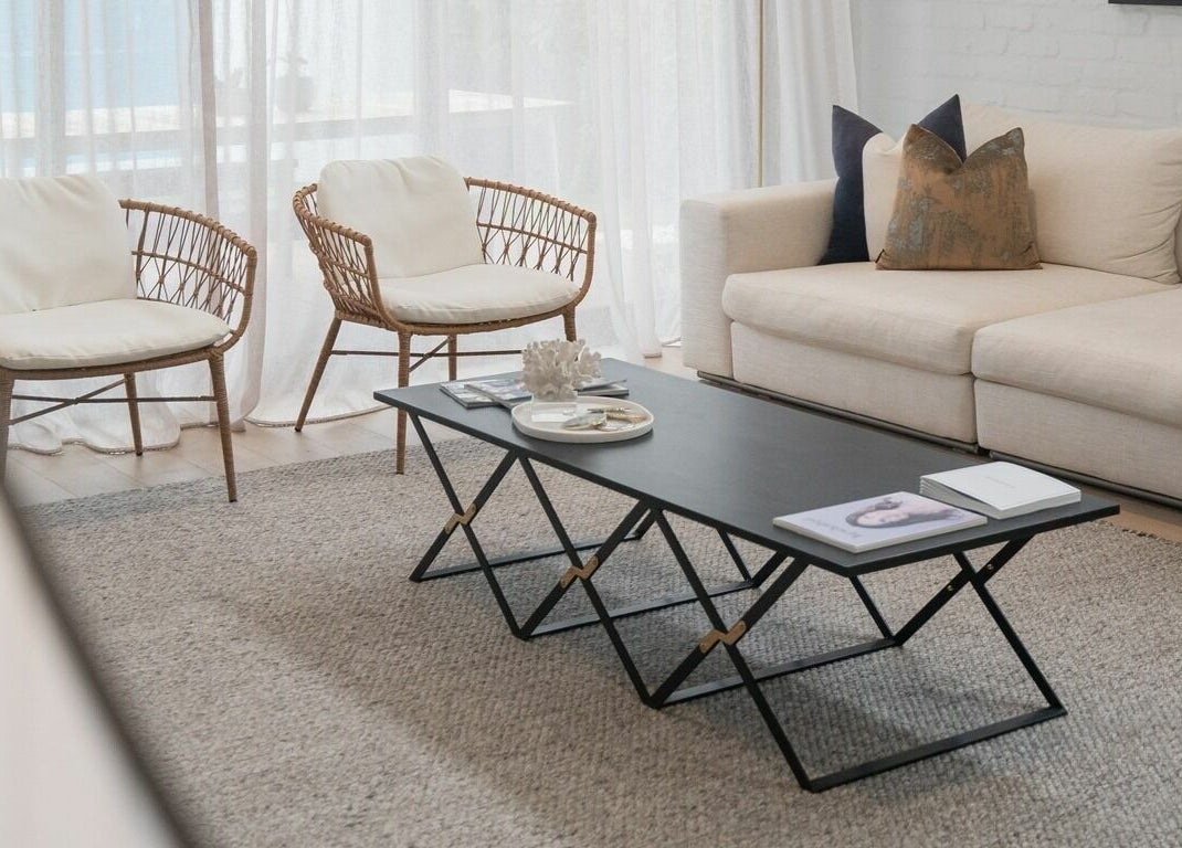 Stylish seating area at By Stella in Cronulla, New South Wales, AU, featuring modern decor and a comfortable couch.