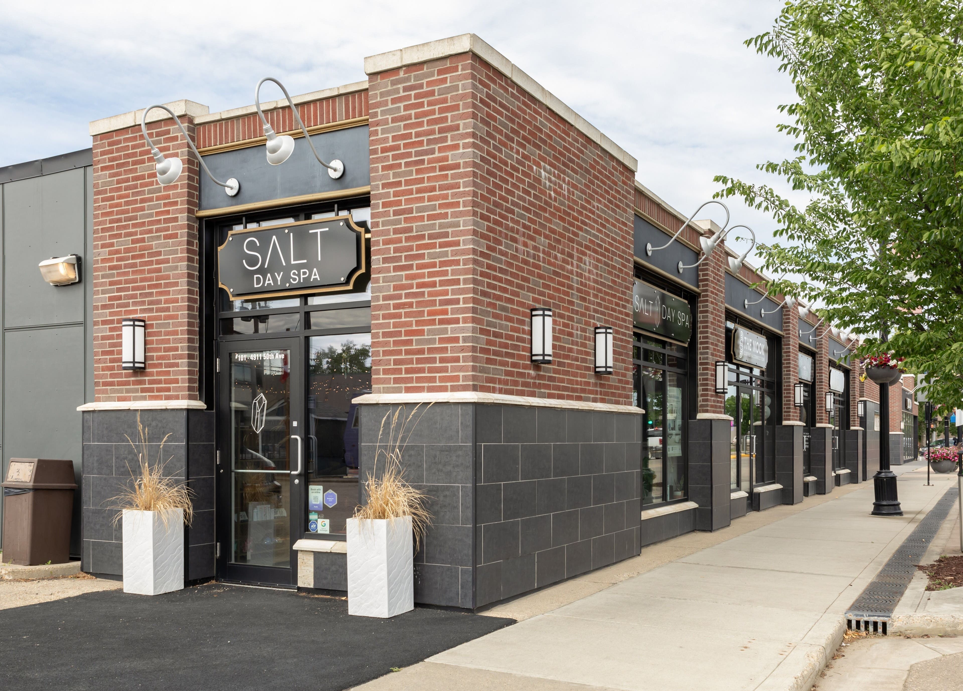 Front view of Salt Day Spa in Leduc, Alberta, CA showcasing modern entrance and brick facade.