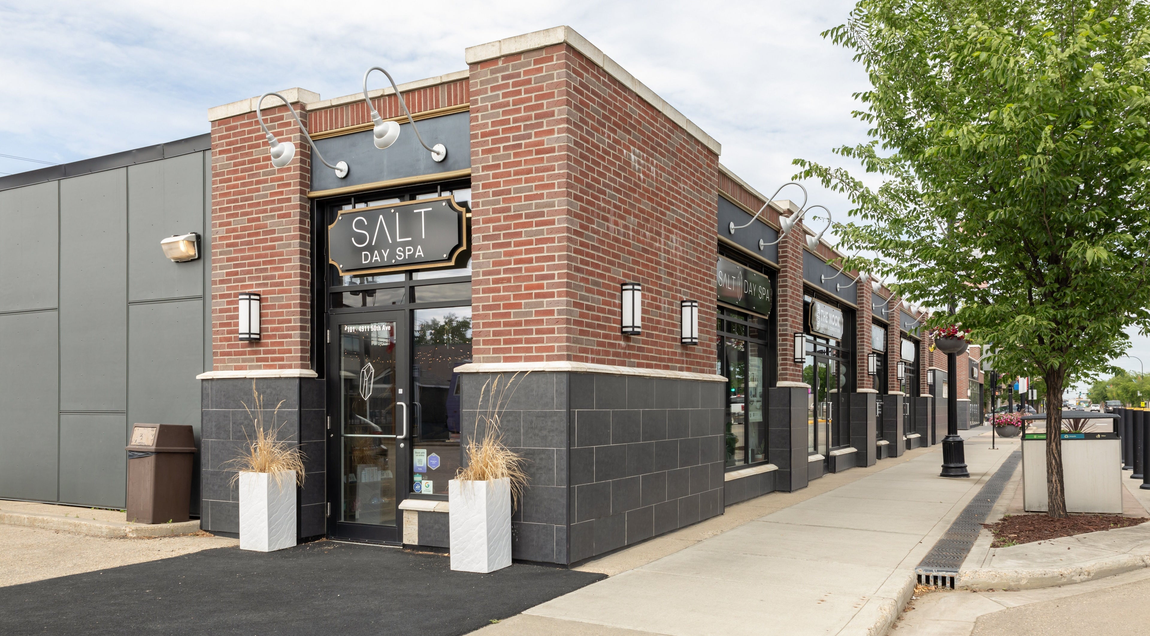Front view of Salt Day Spa in Leduc, Alberta, CA showcasing modern entrance and brick facade.